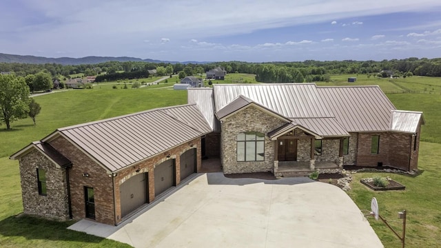 view of front of property with a garage, metal roof, a front lawn, and a standing seam roof