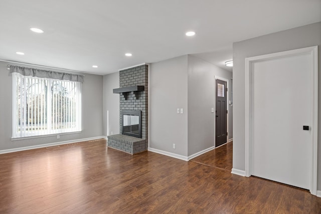 unfurnished living room featuring a fireplace, wood finished floors, and recessed lighting