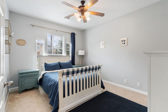 bedroom featuring light carpet, ceiling fan, and baseboards