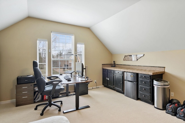 office area with lofted ceiling, light carpet, and baseboards