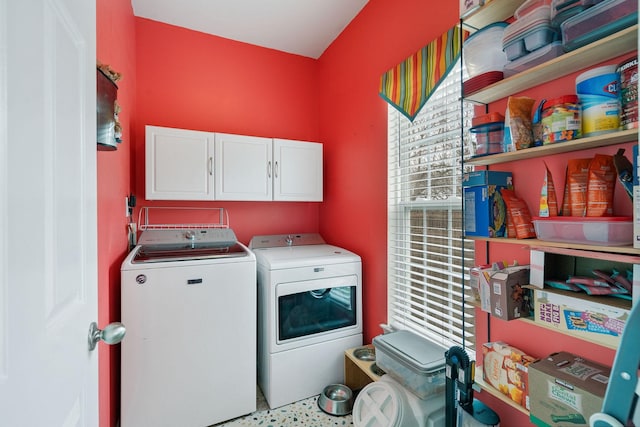 clothes washing area with cabinet space and independent washer and dryer