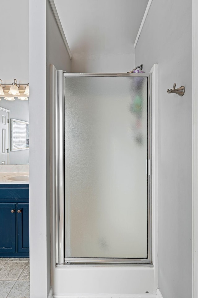 bathroom featuring a stall shower, tile patterned flooring, and vanity