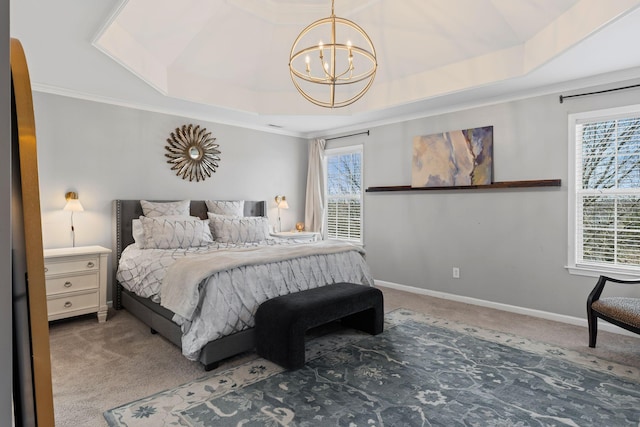 carpeted bedroom with ornamental molding, a tray ceiling, baseboards, and an inviting chandelier