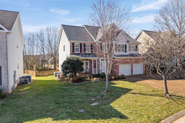 traditional home featuring a garage, covered porch, brick siding, driveway, and a front yard