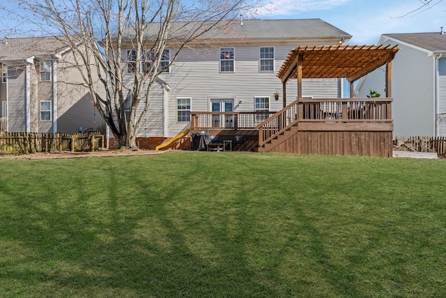 back of property featuring a deck, a lawn, fence, and a pergola