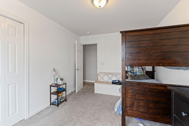 bedroom featuring baseboards and light colored carpet