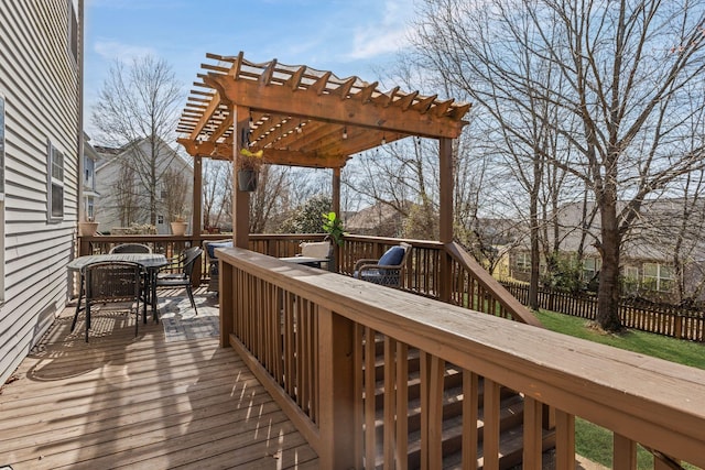 deck with outdoor dining area, fence, and a pergola