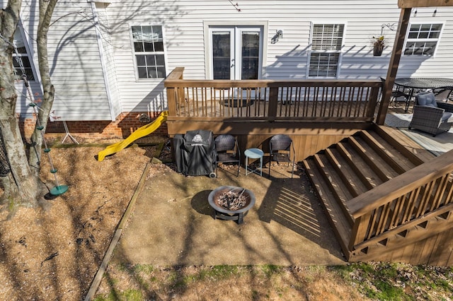 wooden terrace with a fire pit