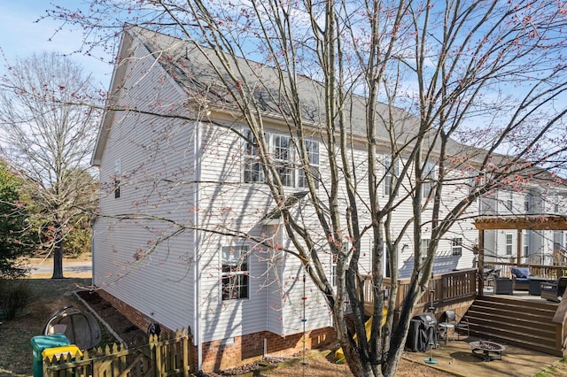 view of home's exterior featuring a deck and a pergola