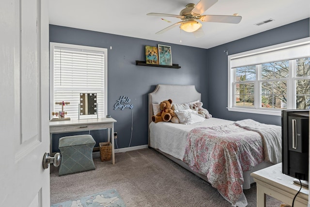 carpeted bedroom with ceiling fan, visible vents, and baseboards