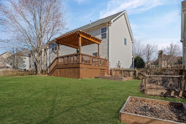 back of property with a garden, a yard, a wooden deck, and a pergola