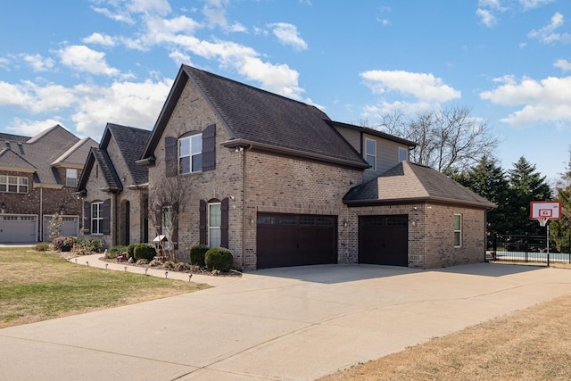 view of front of property featuring concrete driveway, fence, brick siding, and a shingled roof