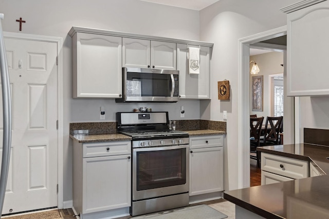 kitchen featuring dark countertops and appliances with stainless steel finishes