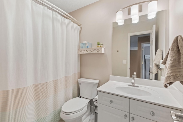 bathroom featuring toilet, a shower with curtain, and vanity