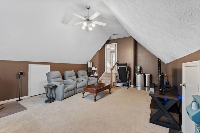 interior space with baseboards, a ceiling fan, vaulted ceiling, and a textured ceiling