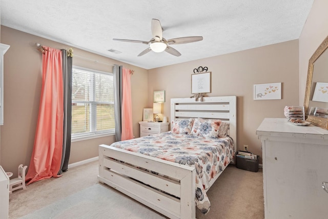 bedroom featuring visible vents, carpet flooring, ceiling fan, a textured ceiling, and baseboards