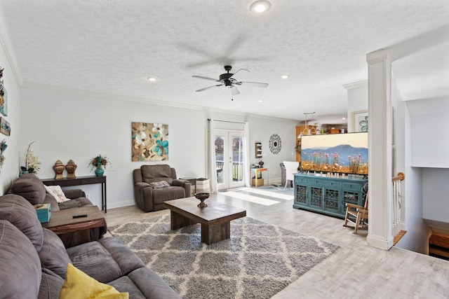 living room with crown molding, wood finished floors, french doors, and a textured ceiling