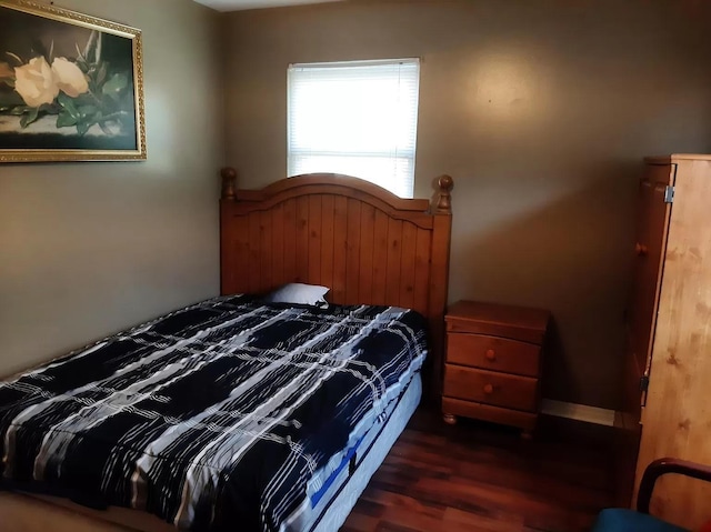bedroom with dark wood-type flooring