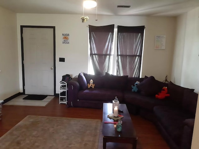 living room featuring wood finished floors and visible vents