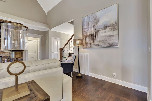 living area with wood finished floors, visible vents, baseboards, stairs, and vaulted ceiling