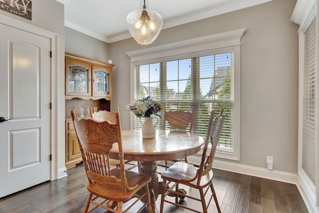 dining room featuring baseboards, ornamental molding, a chandelier, and dark wood-style flooring