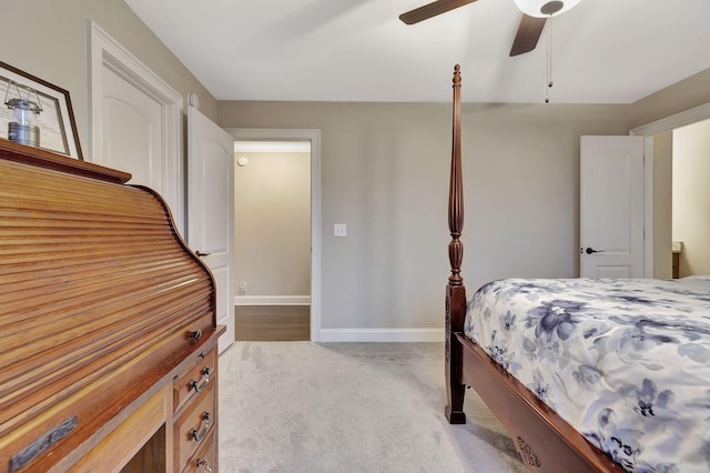 carpeted bedroom featuring a ceiling fan and baseboards