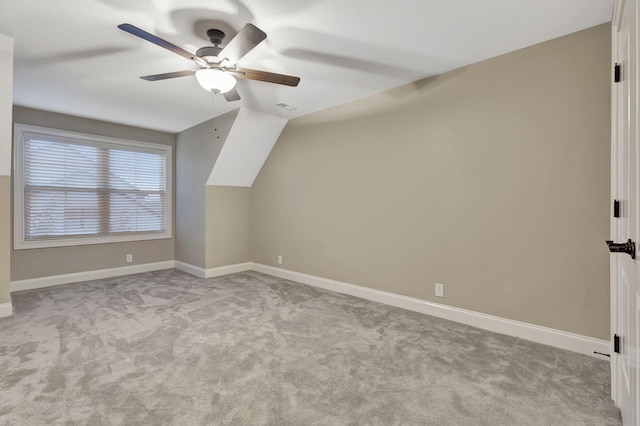 additional living space with carpet, vaulted ceiling, ceiling fan, and baseboards