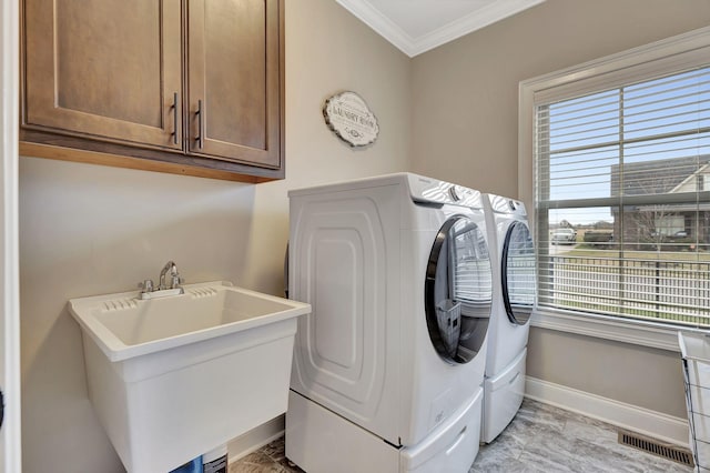 laundry area with baseboards, visible vents, washer and clothes dryer, ornamental molding, and a sink