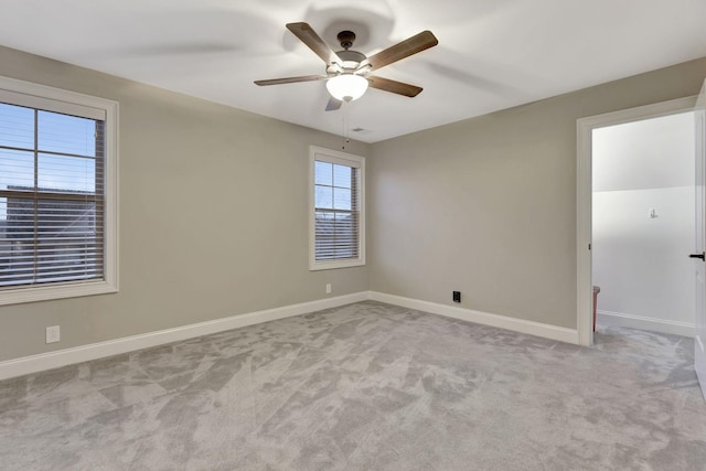 spare room with ceiling fan, carpet floors, and baseboards