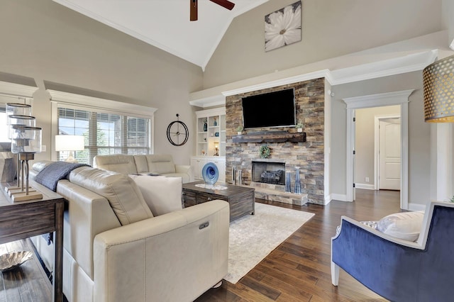 living room with dark wood-style flooring, crown molding, ceiling fan, a stone fireplace, and high vaulted ceiling