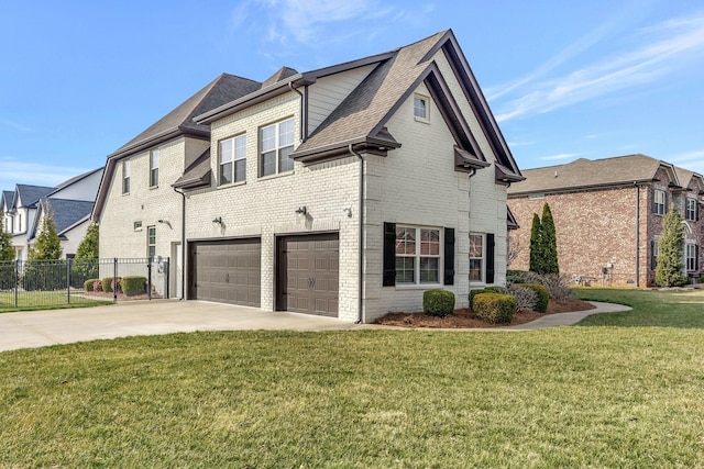 view of side of home featuring brick siding, a yard, concrete driveway, fence, and a garage