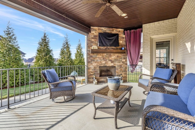 view of patio / terrace with ceiling fan and an outdoor stone fireplace