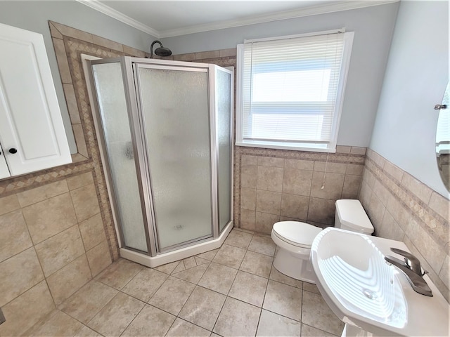 full bath with a shower stall, crown molding, tile walls, and tile patterned floors