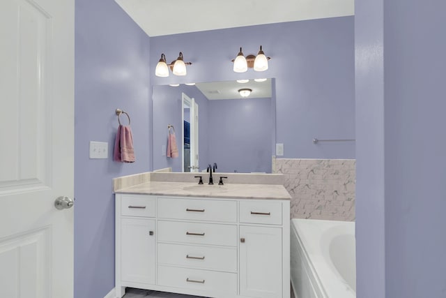 bathroom with a bath and vanity