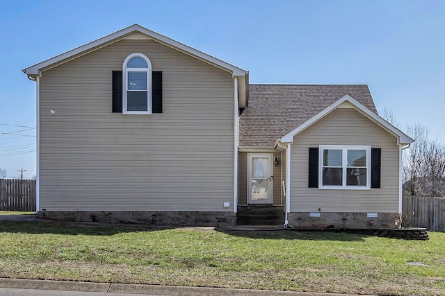 view of front of home featuring entry steps, a shingled roof, crawl space, fence, and a front yard