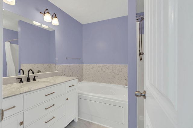 bathroom with a bath and vanity