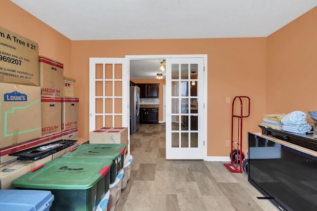 interior space featuring baseboards and french doors