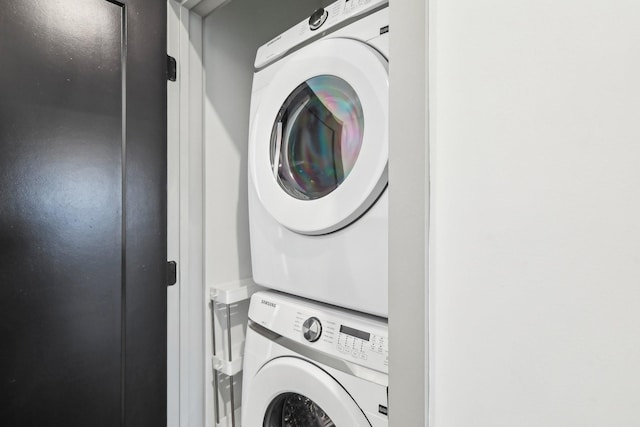 washroom with laundry area and stacked washing maching and dryer