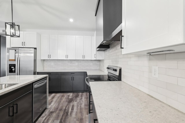 kitchen with pendant lighting, dark wood finished floors, stainless steel appliances, decorative backsplash, and white cabinets