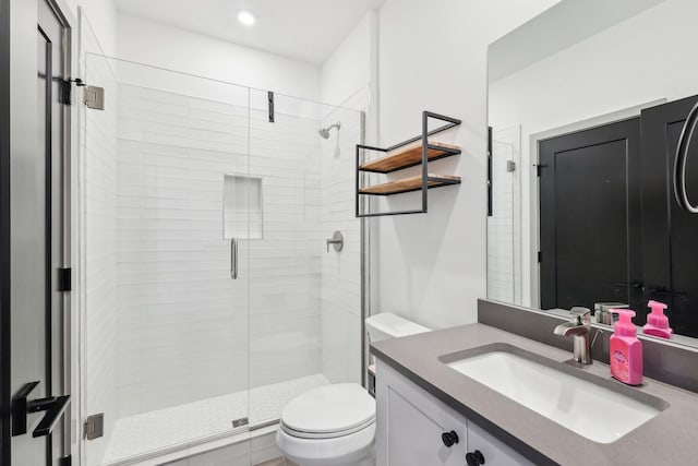 bathroom featuring vanity, a shower stall, toilet, and recessed lighting