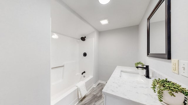 bathroom with shower / bath combination, vanity, and wood finished floors