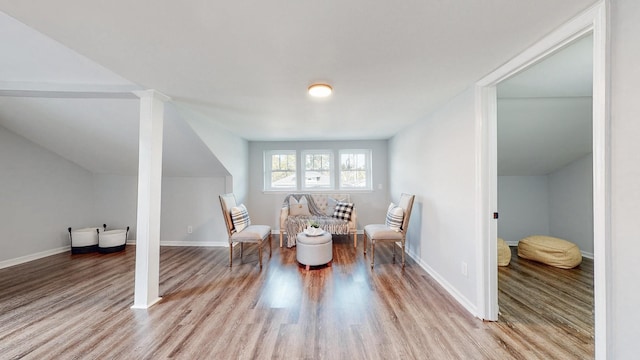 interior space with baseboards and wood finished floors