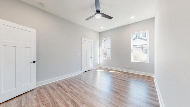 empty room featuring light wood-style floors, recessed lighting, baseboards, and a ceiling fan