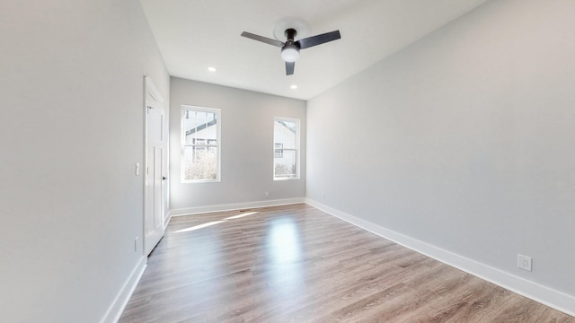 unfurnished room featuring a ceiling fan, baseboards, wood finished floors, and recessed lighting