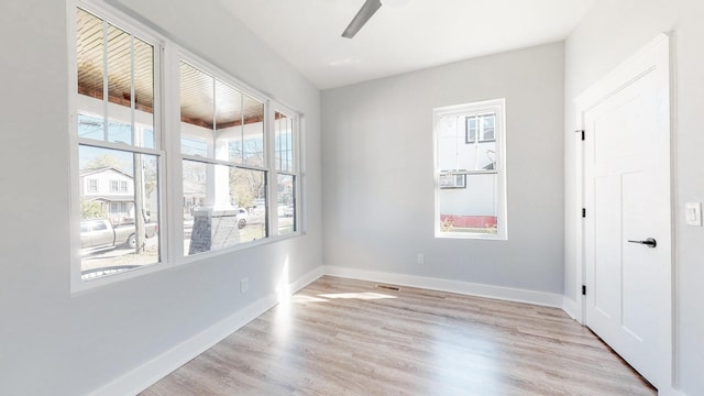 empty room featuring light wood finished floors and baseboards