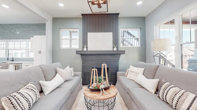 living room featuring a fireplace and recessed lighting