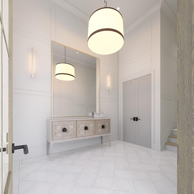 interior space featuring crown molding, marble finish floor, and a decorative wall