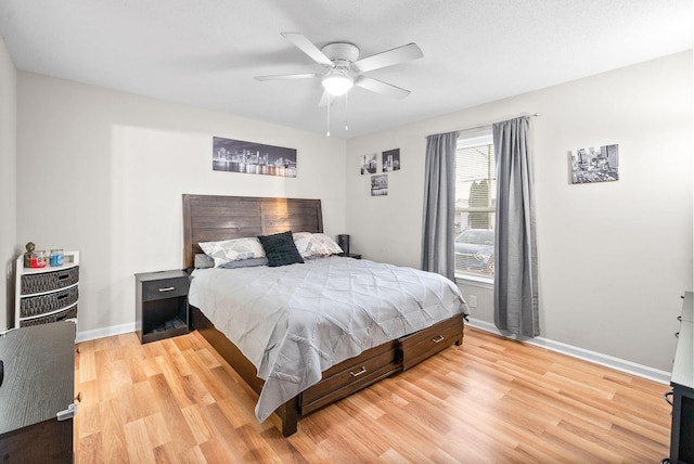 bedroom featuring light wood-style floors, ceiling fan, and baseboards