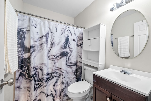 bathroom featuring toilet, curtained shower, and vanity