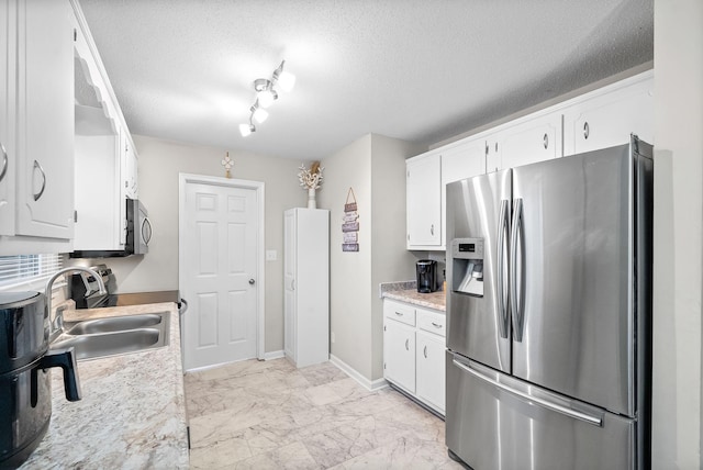 kitchen with stainless steel appliances, marble finish floor, white cabinetry, and a sink